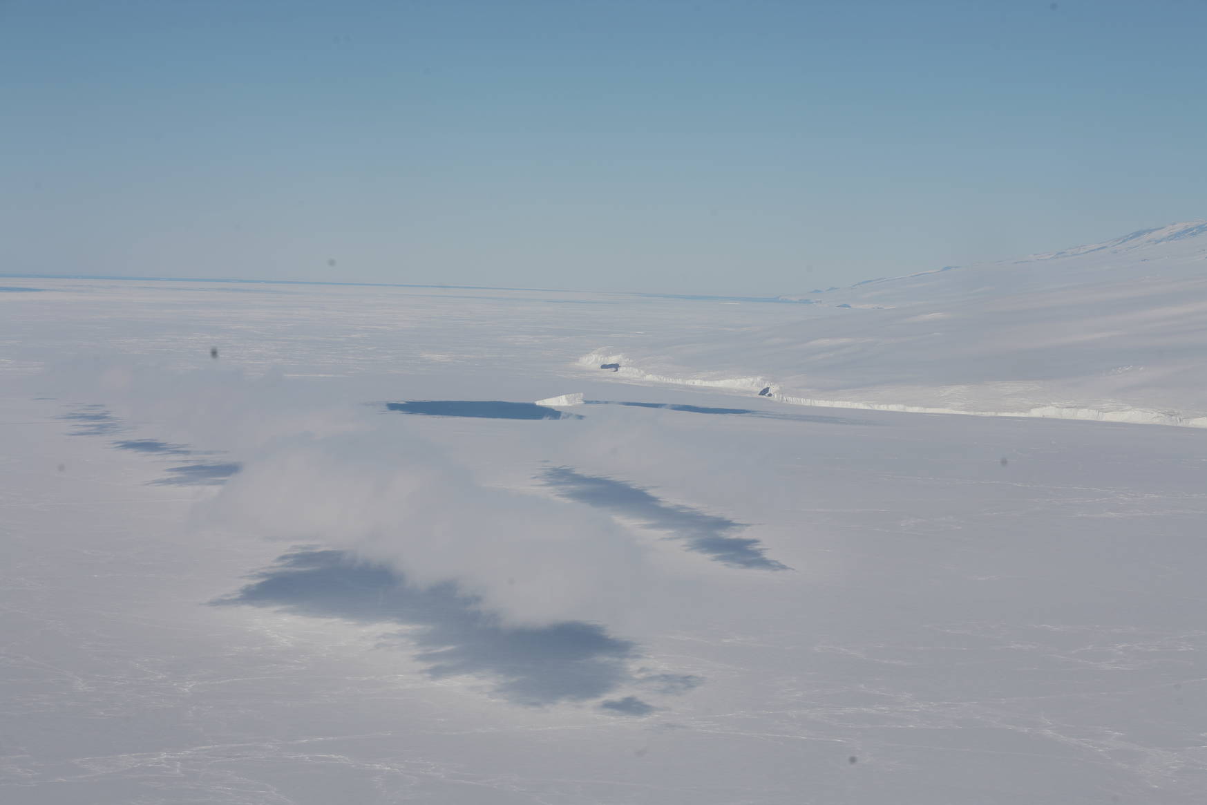 Low-hanging clouds above the Antarctic coast.
