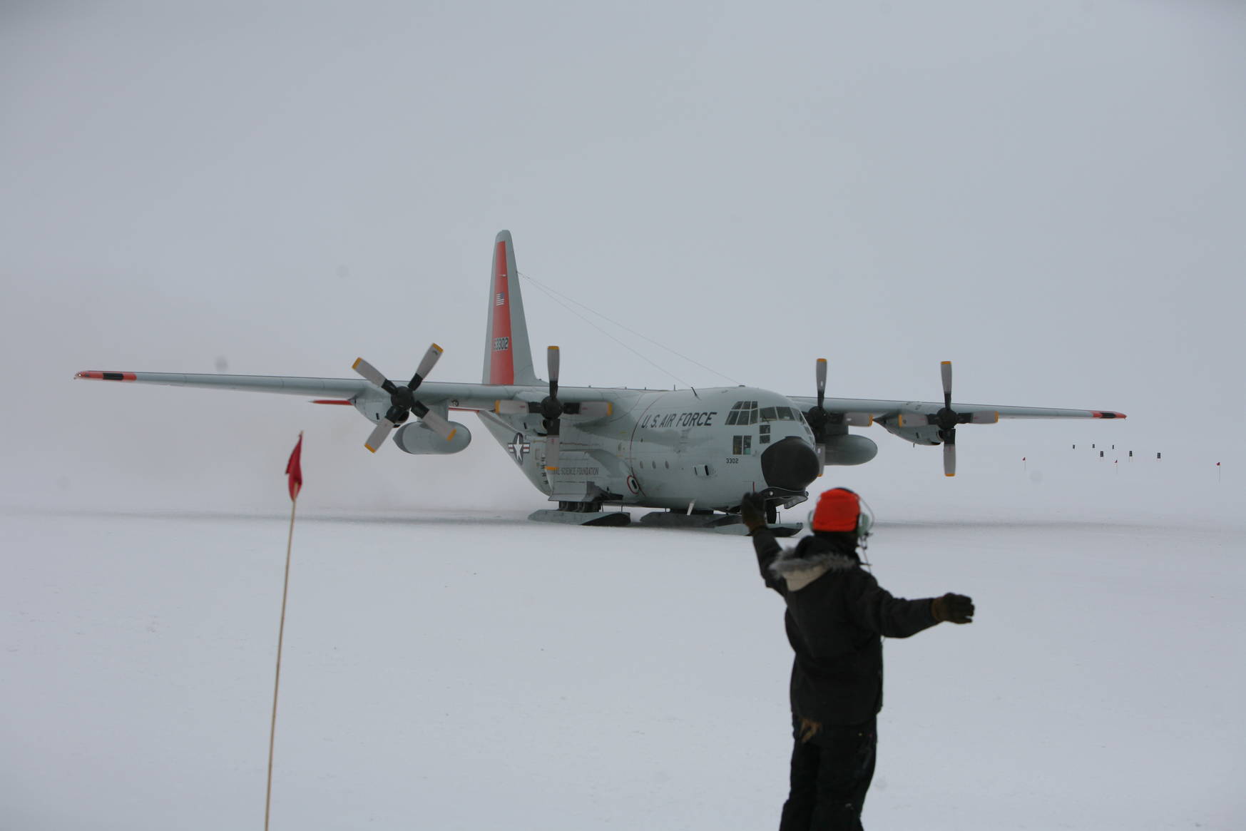 Corey directing a Hercules aircraft into its parking position.