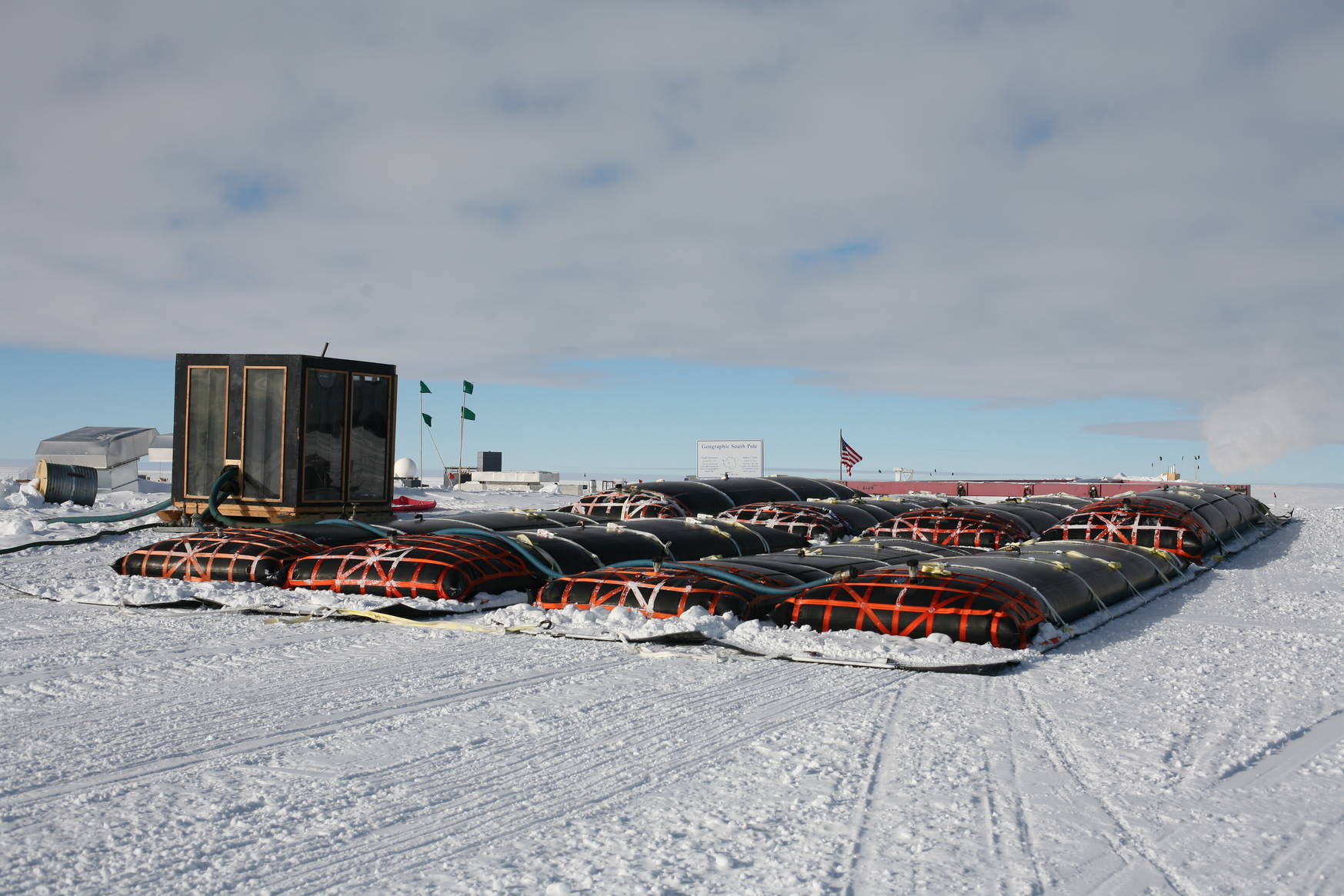 Close-up of the fuel bladders. Each bladder is over 10000 litres. In the background the pump shack and the geographical south pole marker.
